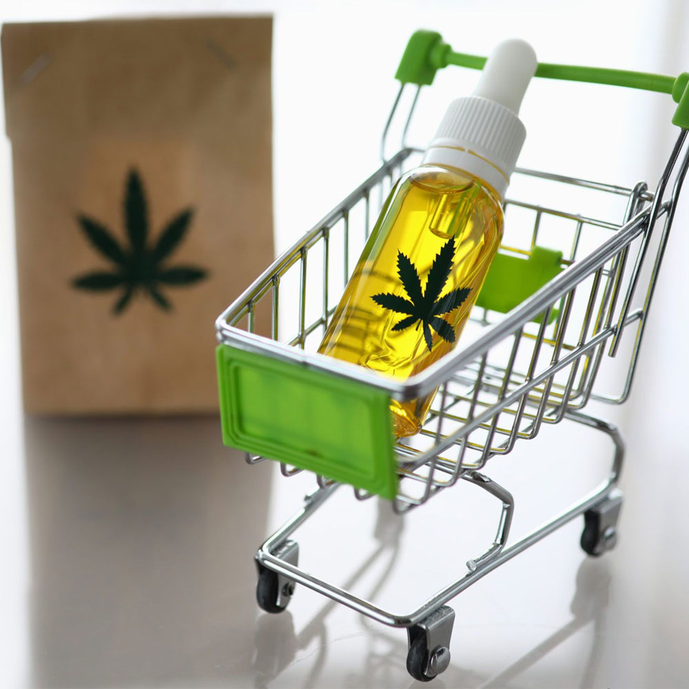 Mini cart with bottle of hemp oil inside it