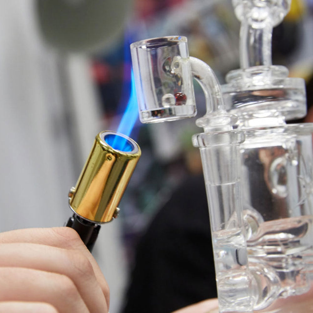 Dab rig nail being heated by blow torch