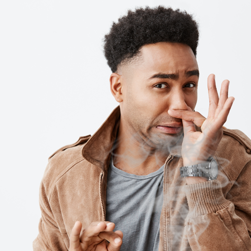 Man pinches nose from vape smoke