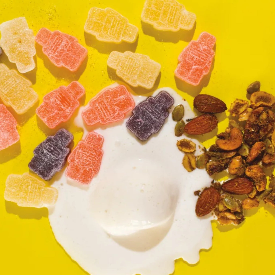 CBD gummies nuts and ice cream on yellow table