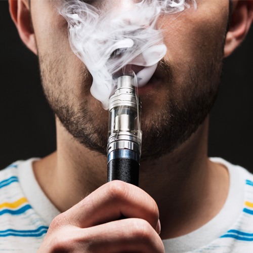 Young man vaping and smoke
