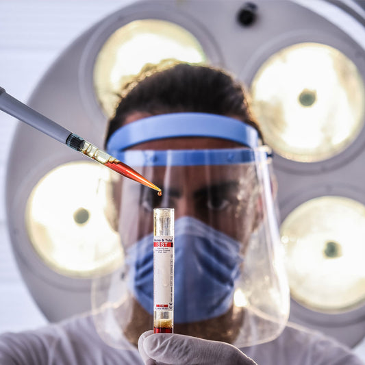 Scientist hold a test tube and squeezing liquid into it