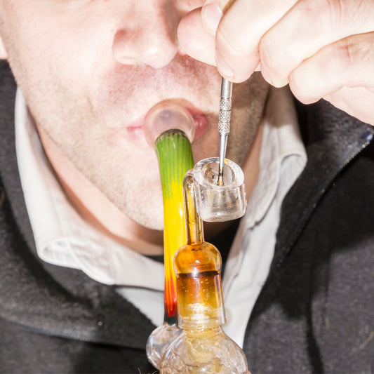 A man taking a dab from a dab rig