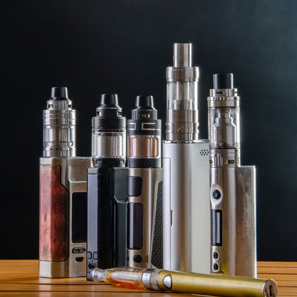 Box mod vapes on a flat surface