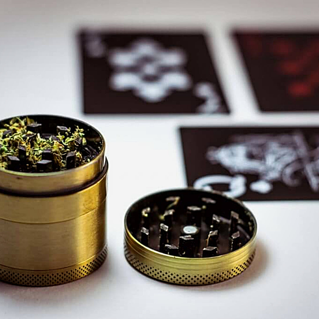 Herb grinder with herbs inside the top blades
