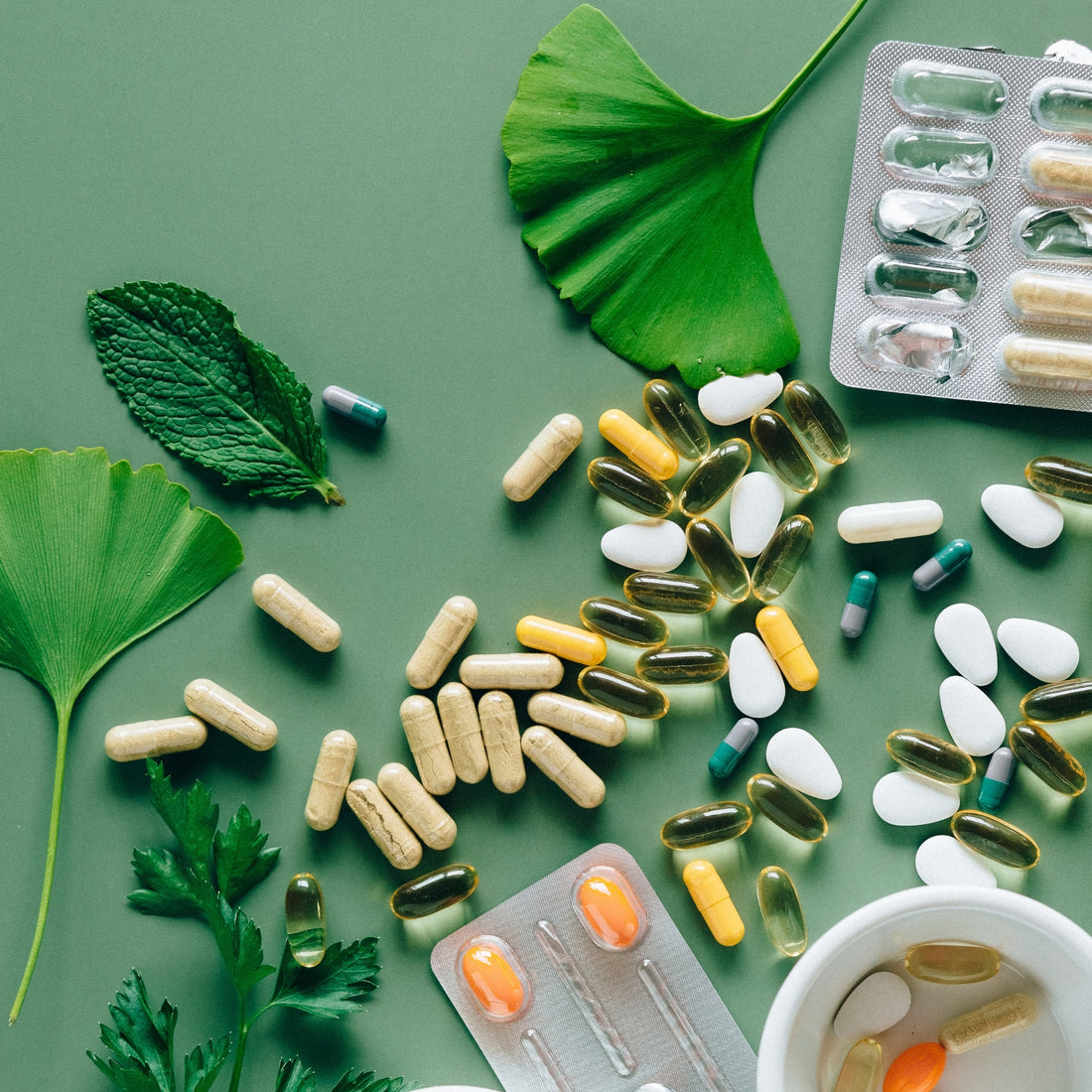 Medications scattered on table around flower petals