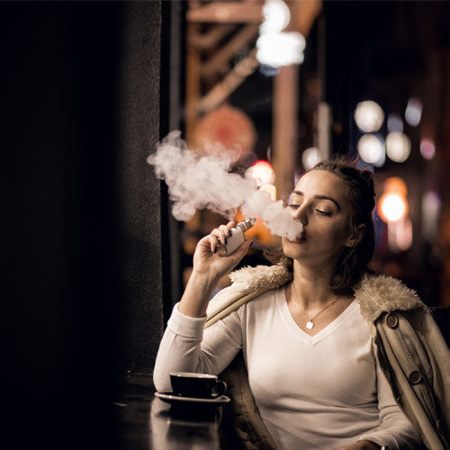 Girl vaping and taking coffee