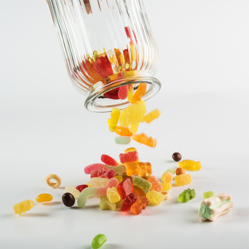 Gummies poured out of glass jar