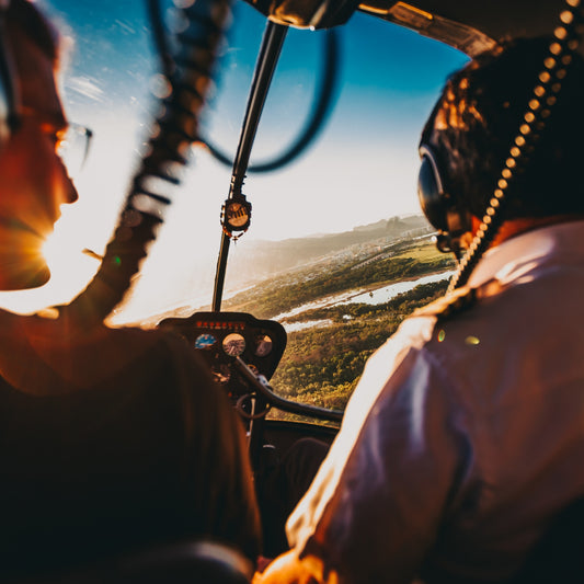 Inside airplane cockpit looking out over pilots and windshield