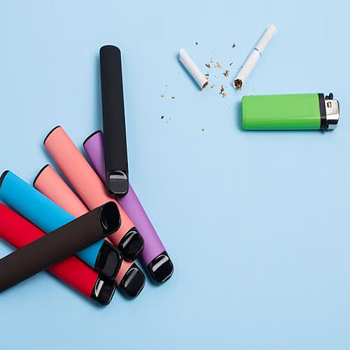 Vapes, Cigarette and a Lighter on a flat surface